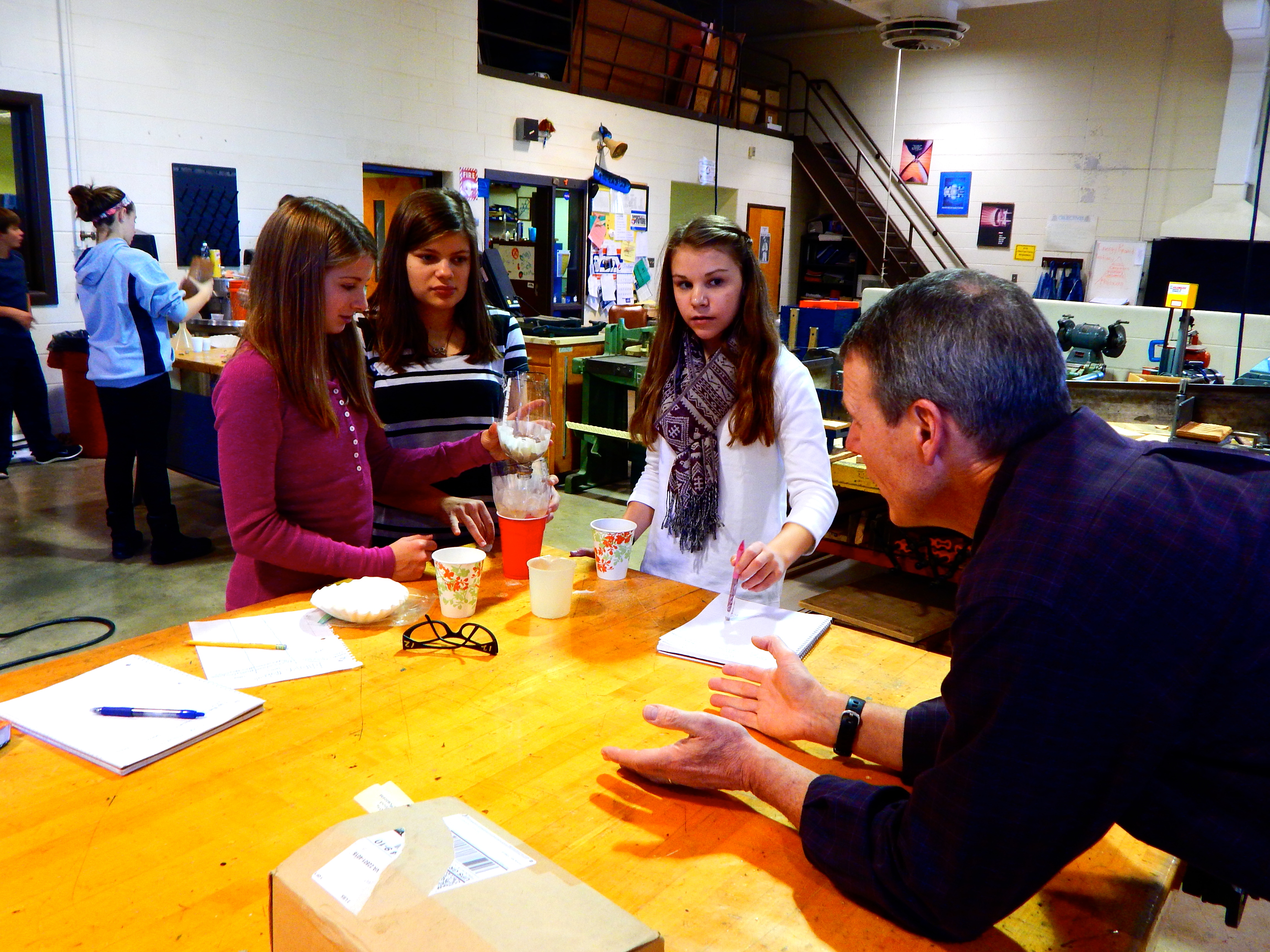 Abby, Anna and Christa share their findings with the coordinator of the STEM program.